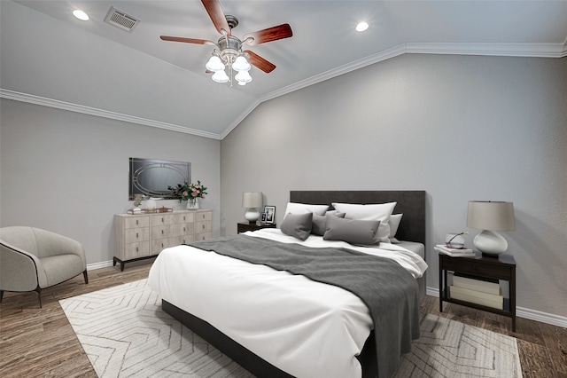 bedroom with ceiling fan, lofted ceiling, and crown molding