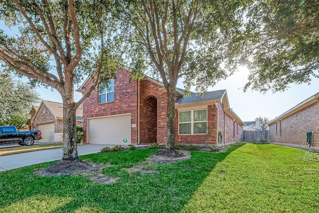 traditional-style house with a front yard, fence, concrete driveway, a garage, and brick siding