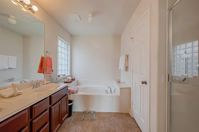 bathroom with visible vents, a shower stall, double vanity, a bath, and a sink