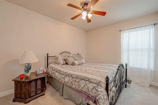 bedroom with ceiling fan, baseboards, and carpet