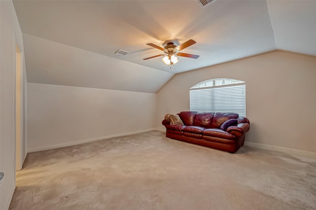 interior space featuring vaulted ceiling, a ceiling fan, visible vents, and baseboards