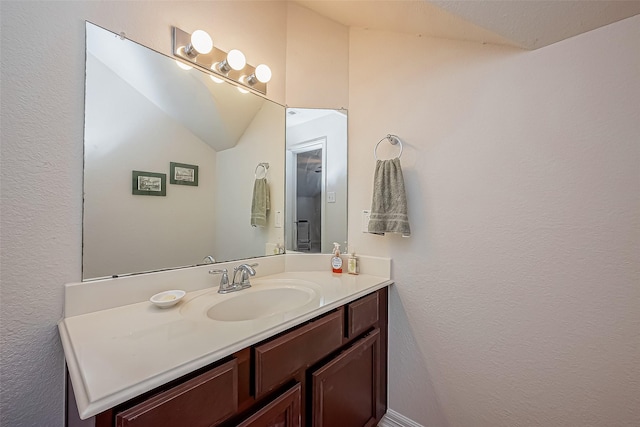 bathroom featuring vanity and vaulted ceiling