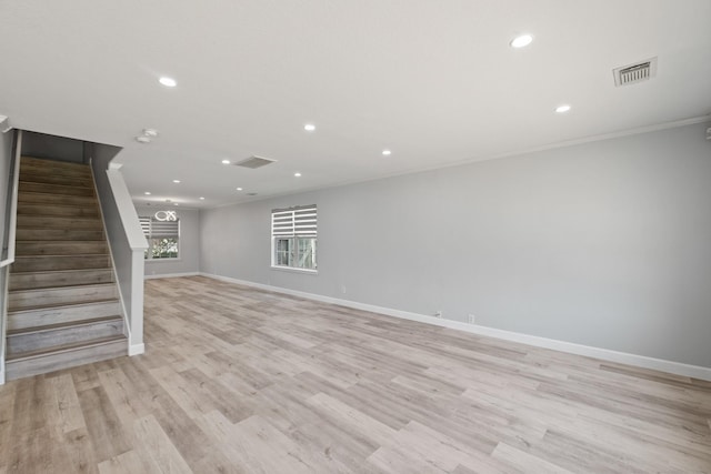 basement featuring ornamental molding and light wood-type flooring