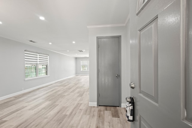 interior space with light wood-type flooring and ornamental molding