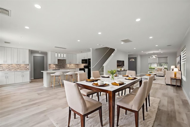 dining space with light wood-type flooring