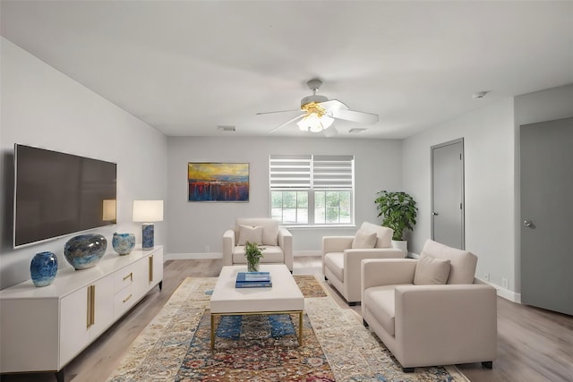 living room featuring light wood-type flooring and ceiling fan