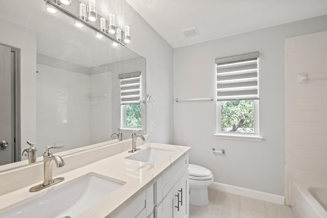 bathroom with tile patterned floors, vanity, and toilet