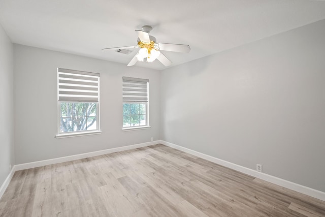 unfurnished room with ceiling fan and light hardwood / wood-style flooring