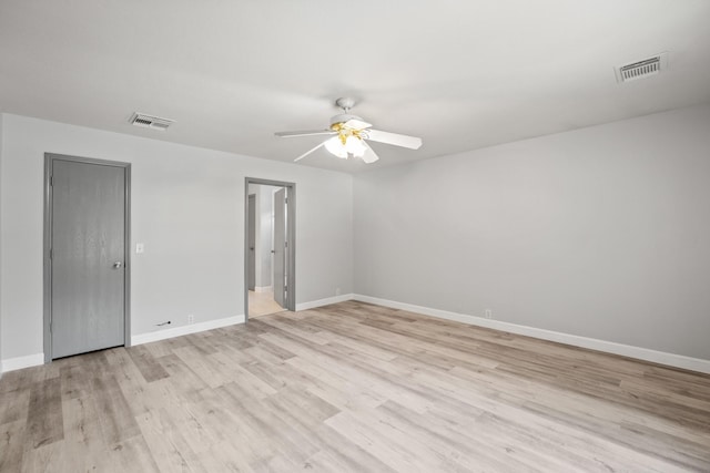 empty room with ceiling fan and light wood-type flooring