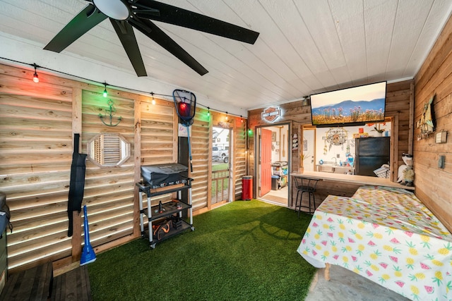 carpeted bedroom with black fridge and ceiling fan