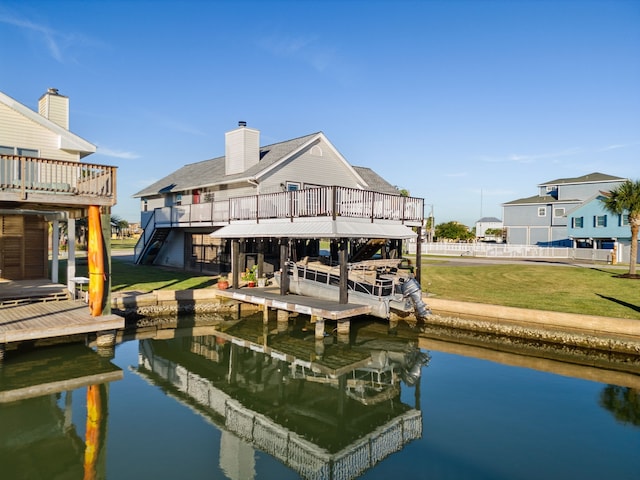 dock area featuring a lawn and a water view