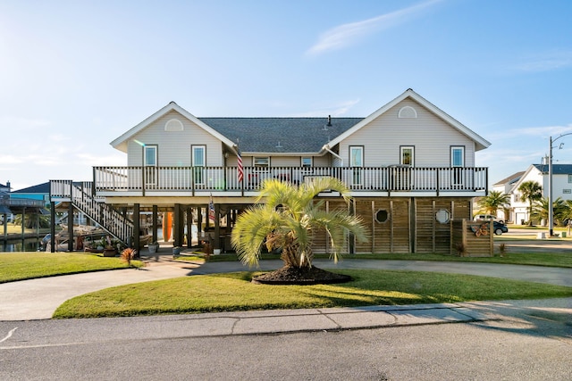 beach home featuring a carport and a front yard