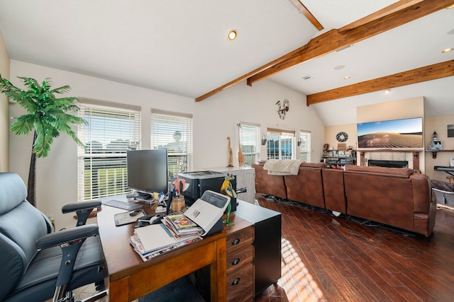 office space featuring vaulted ceiling with beams, a healthy amount of sunlight, dark hardwood / wood-style flooring, and a tile fireplace