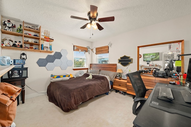 bedroom featuring a textured ceiling, ceiling fan, and light carpet