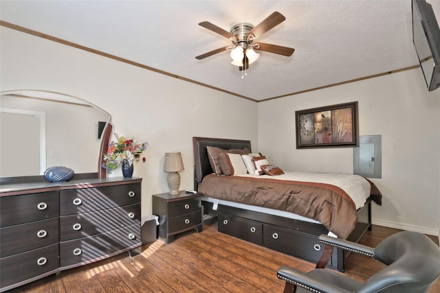 bedroom with hardwood / wood-style flooring, ceiling fan, and ornamental molding