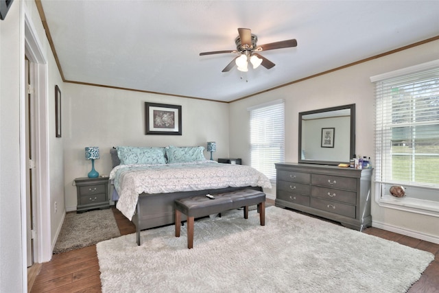 bedroom featuring ornamental molding, ceiling fan, and dark wood-type flooring