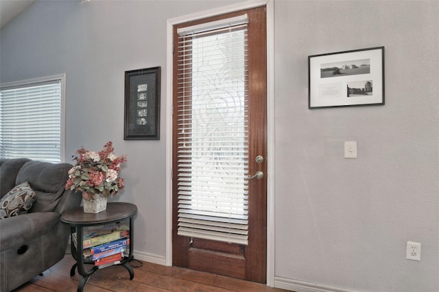 entrance foyer featuring lofted ceiling and hardwood / wood-style flooring