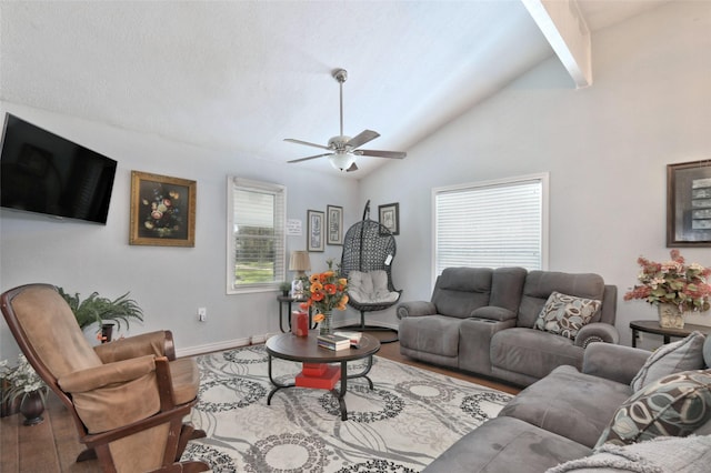 living room with hardwood / wood-style floors, ceiling fan, and vaulted ceiling