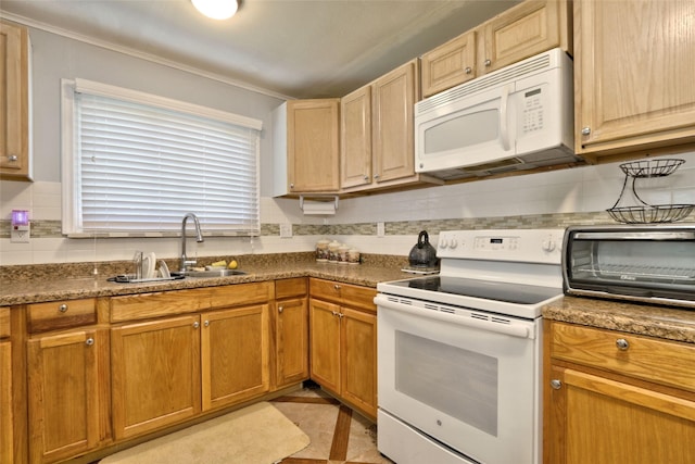 kitchen featuring dark stone countertops, sink, light tile patterned flooring, and white appliances