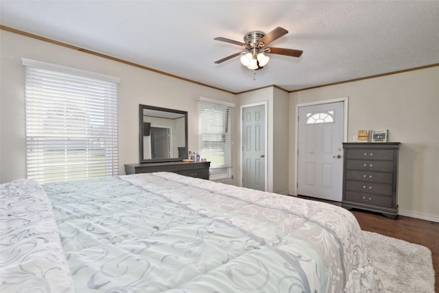 bedroom with ceiling fan, dark hardwood / wood-style flooring, and ornamental molding