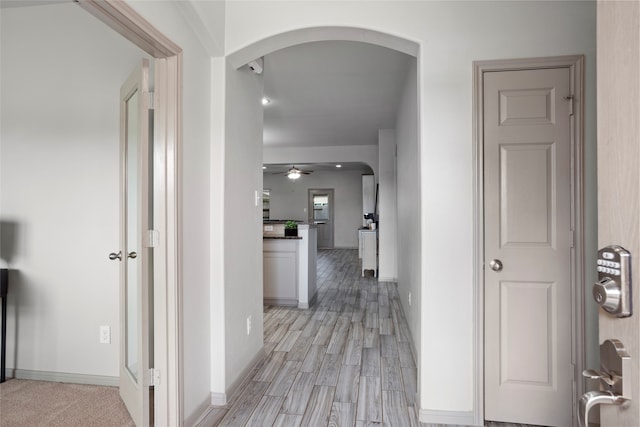 corridor with light hardwood / wood-style floors