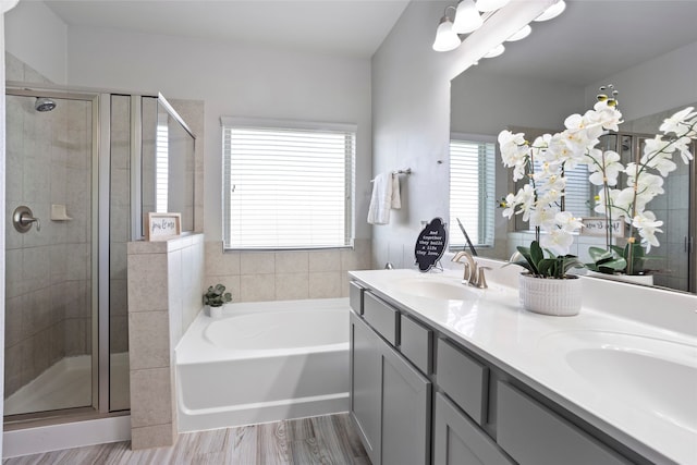 bathroom featuring plus walk in shower, hardwood / wood-style floors, and vanity