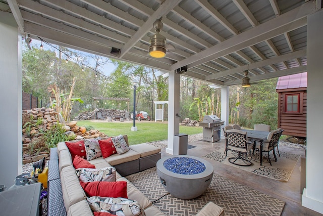 view of patio / terrace with a grill and an outdoor living space with a fire pit