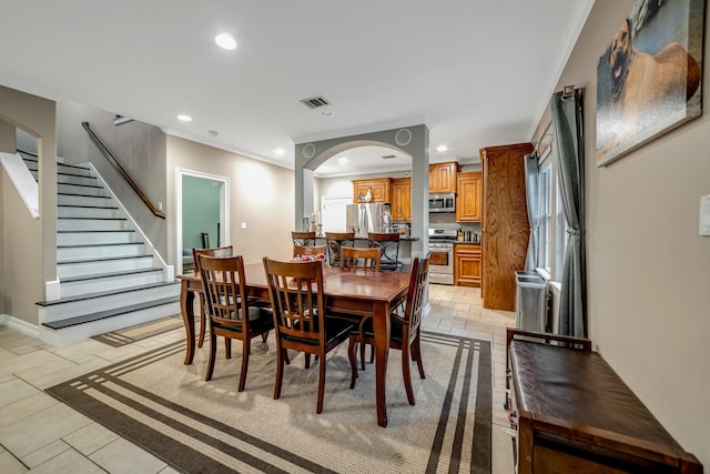 tiled dining room with ornamental molding