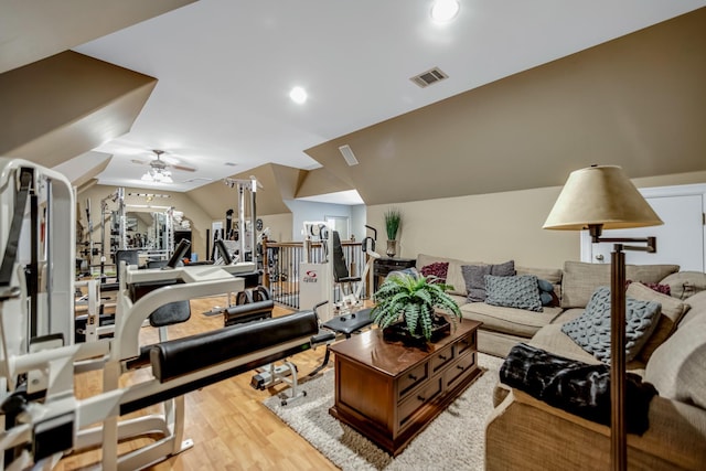 interior space featuring ceiling fan, vaulted ceiling, and light wood-type flooring