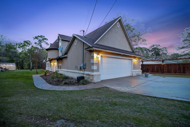 property exterior at dusk featuring a lawn