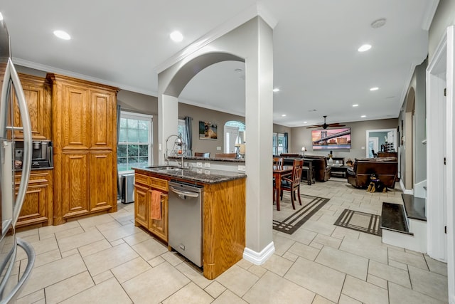 kitchen featuring dishwasher, ceiling fan, dark stone countertops, and crown molding