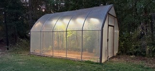 view of outbuilding featuring a lawn