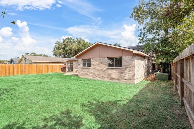 rear view of property featuring a lawn