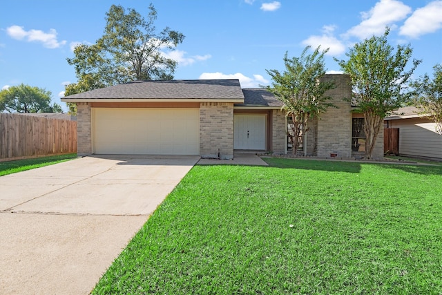 single story home with a front yard and a garage