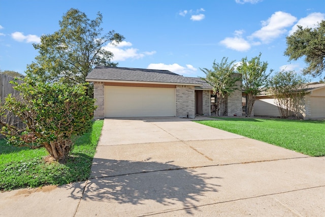 view of front facade with a front yard and a garage