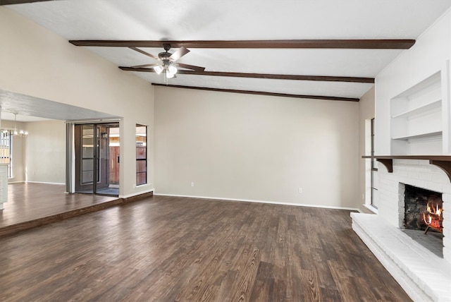 unfurnished living room featuring beamed ceiling, ceiling fan with notable chandelier, dark wood-type flooring, and a brick fireplace