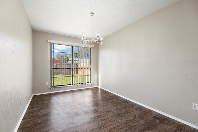 unfurnished dining area featuring a chandelier and dark wood-type flooring