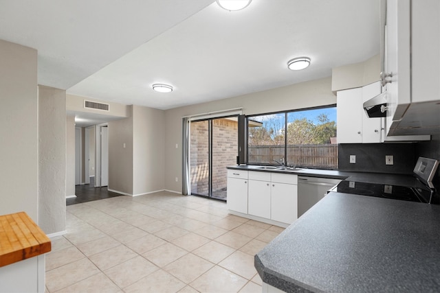 kitchen with sink, dishwasher, range, white cabinetry, and light tile patterned flooring