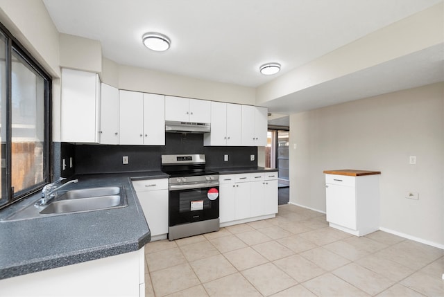 kitchen featuring decorative backsplash, stainless steel range oven, white cabinetry, and sink