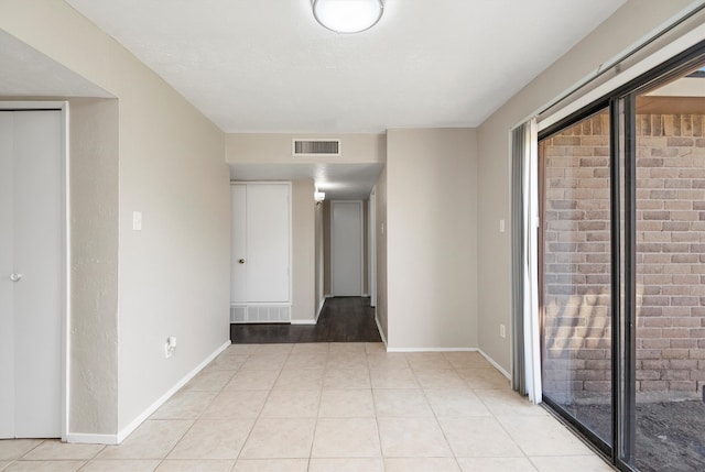 corridor featuring light tile patterned floors