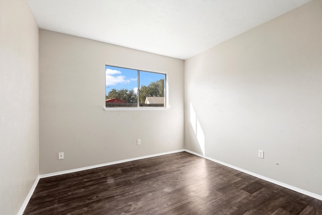 empty room with dark hardwood / wood-style floors