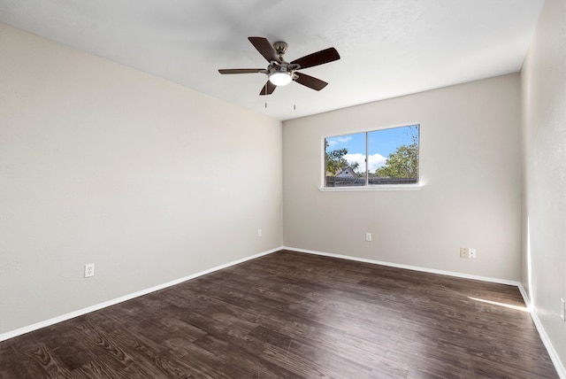 unfurnished room with ceiling fan and dark wood-type flooring