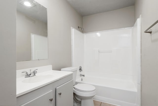 full bathroom featuring a textured ceiling, vanity, shower / washtub combination, tile patterned flooring, and toilet