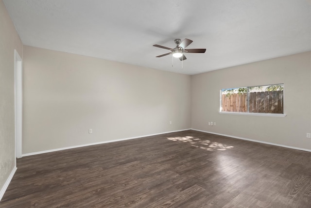 unfurnished room with ceiling fan and dark hardwood / wood-style floors