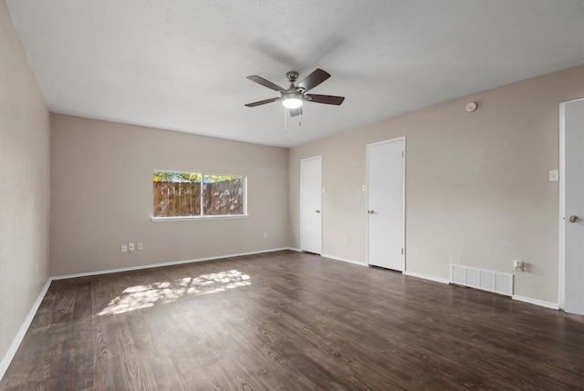 unfurnished room with dark hardwood / wood-style floors and ceiling fan