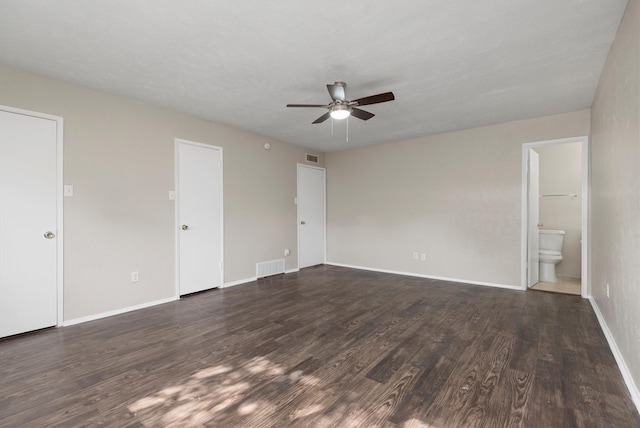 empty room with dark hardwood / wood-style floors, ceiling fan, and a textured ceiling