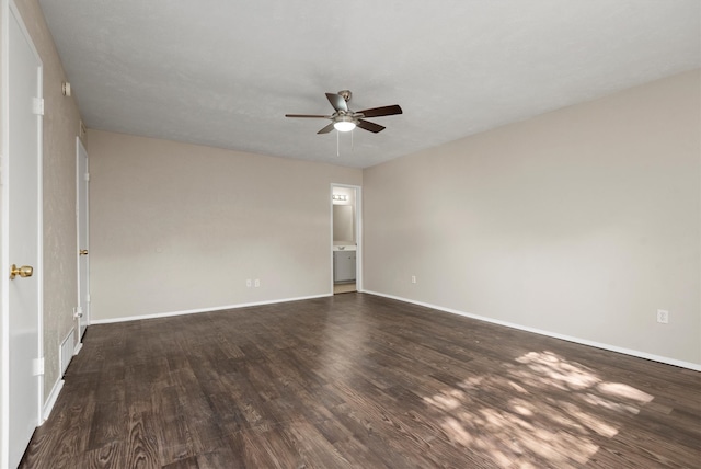 empty room featuring ceiling fan and dark wood-type flooring