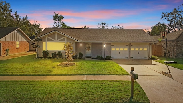 view of front of house featuring a yard and a garage