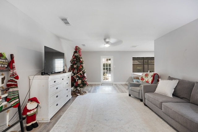 living room featuring ceiling fan and light wood-type flooring