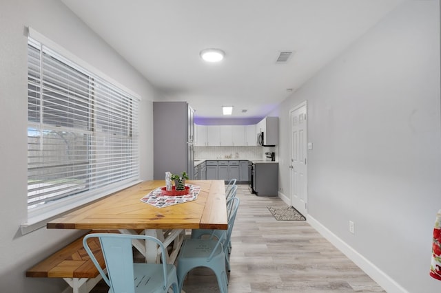 dining space featuring light hardwood / wood-style floors